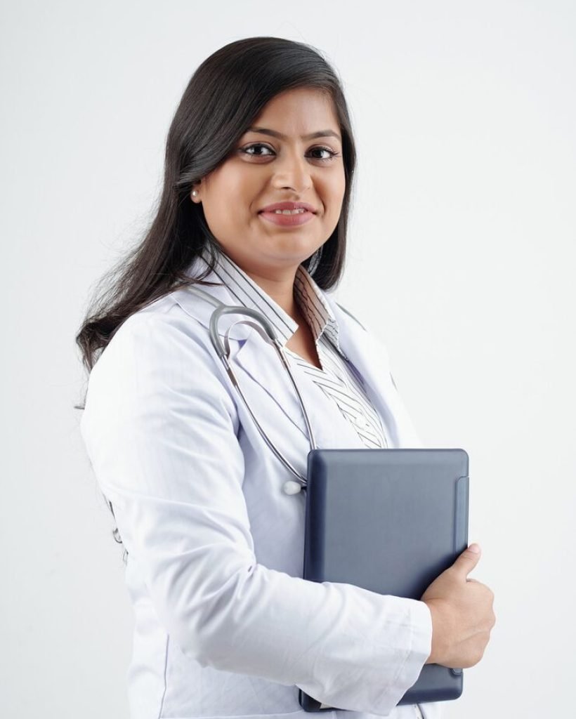 portrait-young-smiling-female-doctor-labcoat-holding-tablet-computer-looking-camera_274689-23407
